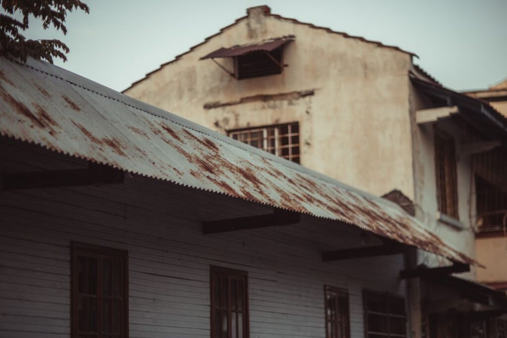 Aged building with deteriorating roof showing signs it needs replacement